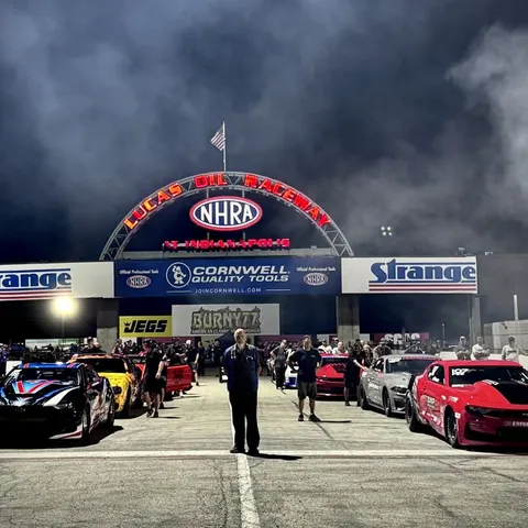 Factory Stock cars lined up under the NHRA gate at Indianapolis
