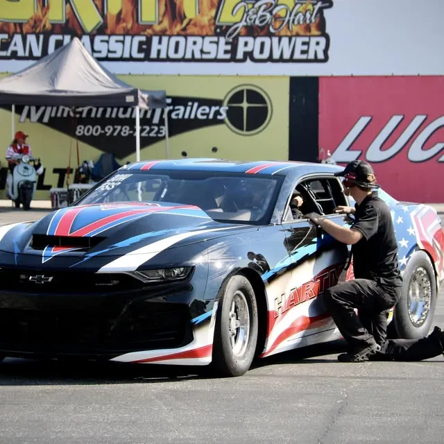 Matthew Hartman's flag-wrapped COPO Camaro being checked over in the pits